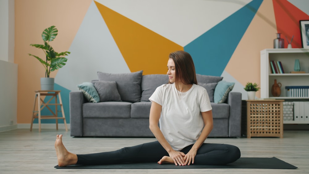 A patient stretching comfortably on a mat in her living room